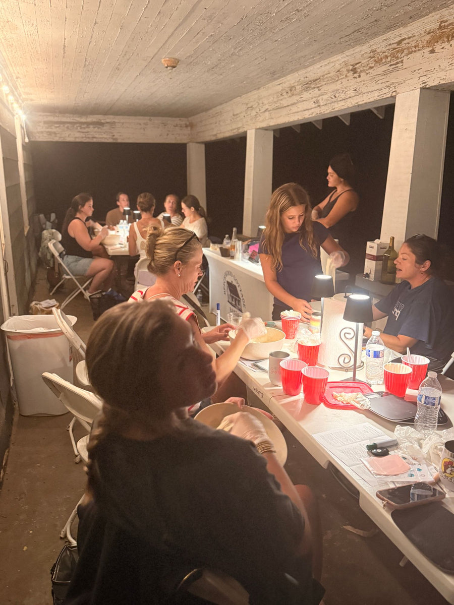 Students mixing dough at a Sourdough Social class on the farmhouse porch